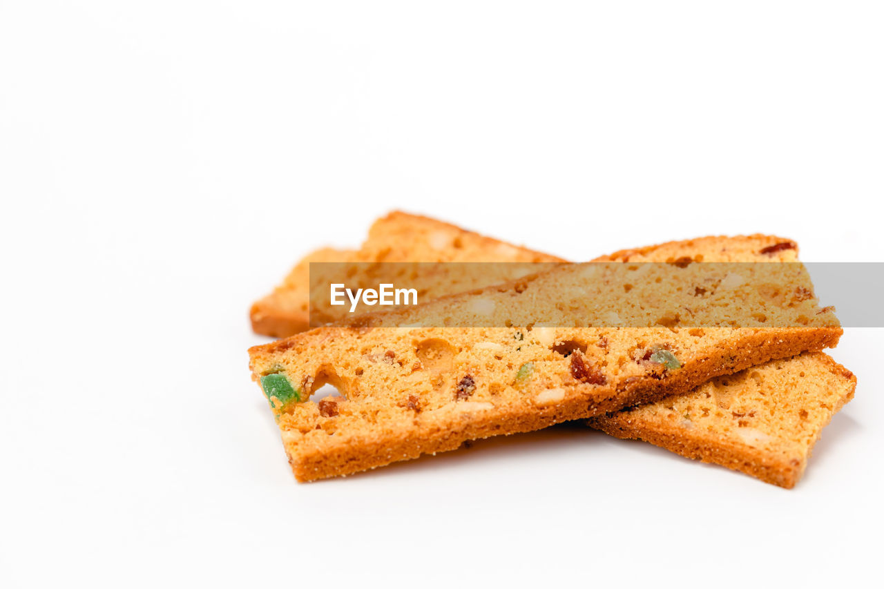 CLOSE-UP OF BREAD ON WHITE BACKGROUND