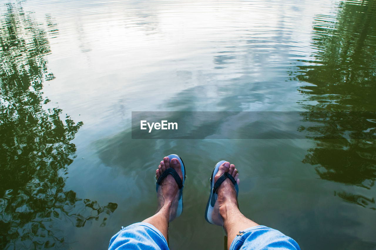 LOW SECTION OF MAN IN LAKE