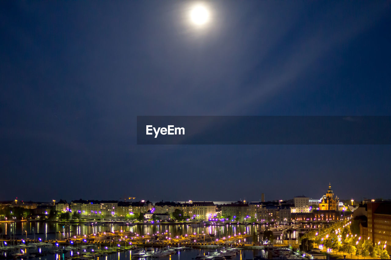 VIEW OF ILLUMINATED CITYSCAPE AT NIGHT