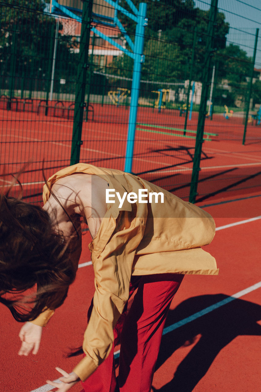 Young woman tossing hair on running track