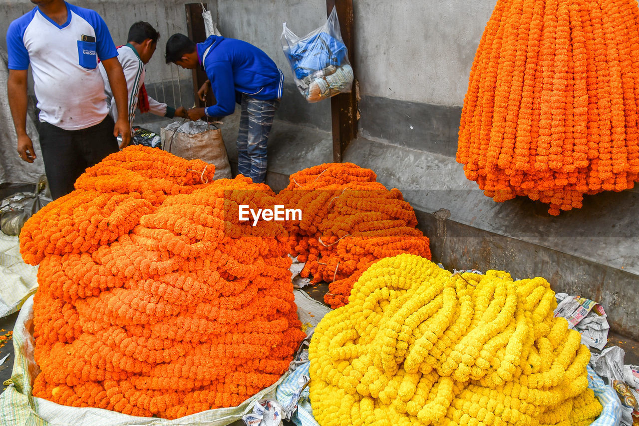 PEOPLE IN MARKET STALL