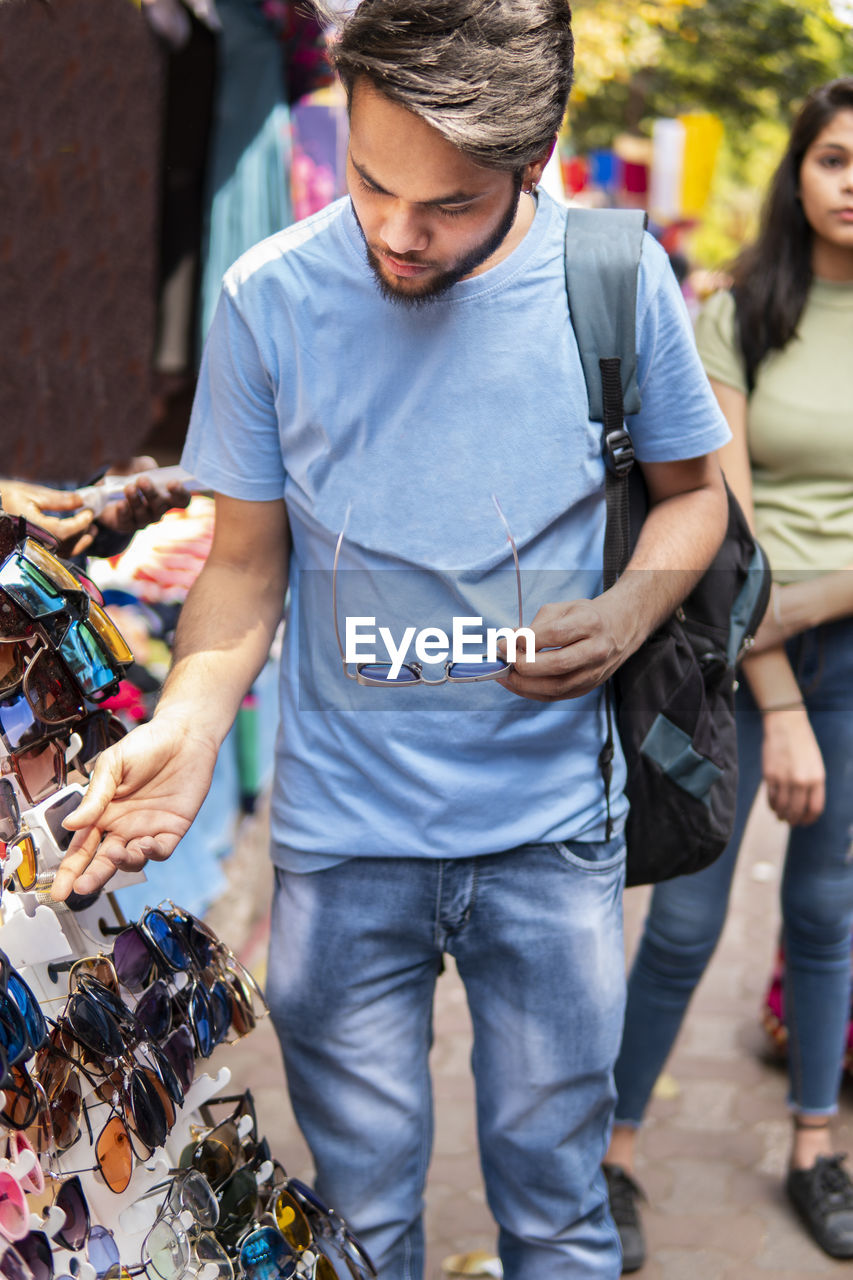 Man looking sunglasses in market