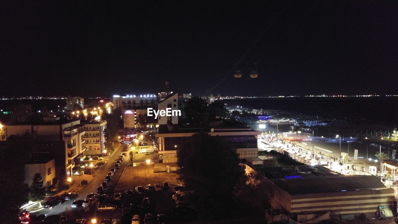 HIGH ANGLE VIEW OF ILLUMINATED CITYSCAPE AT NIGHT