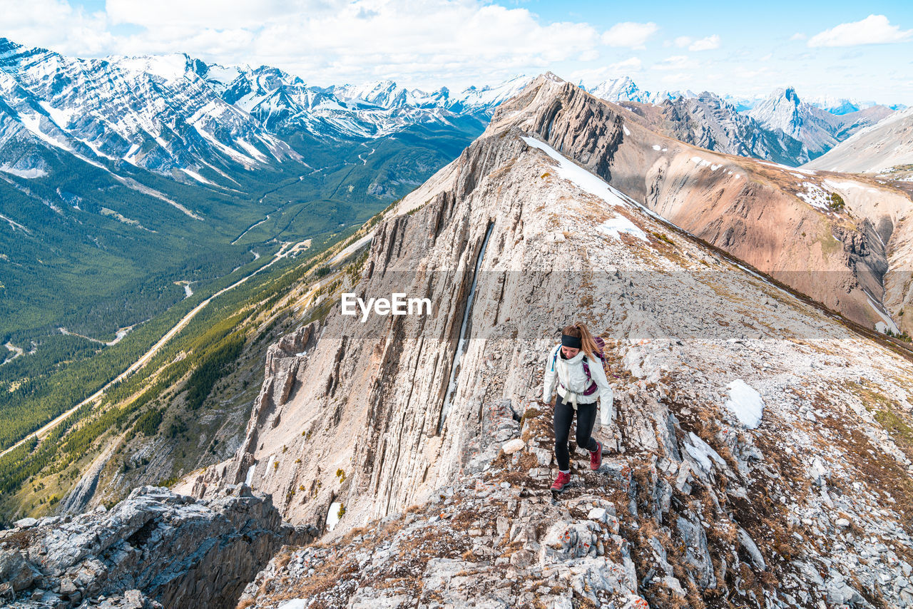 Hiker on grizzly peak summit in kananaskis country canadian rockies