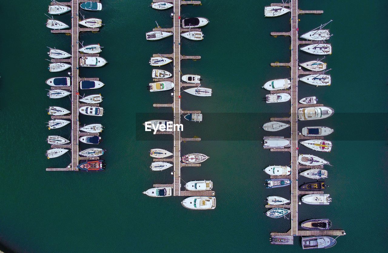 High angle view of boats moored in row