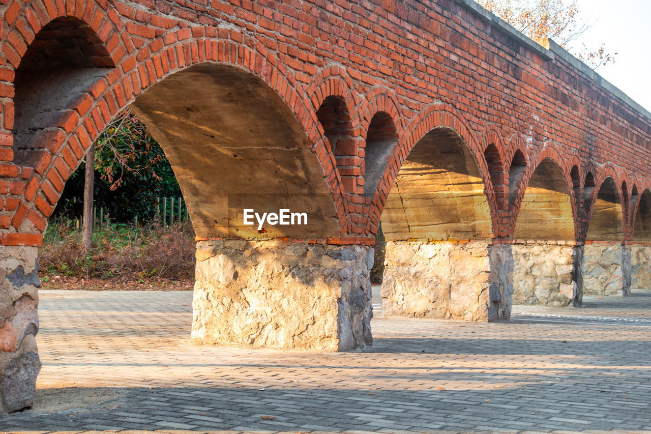 An ancient red arch bridge