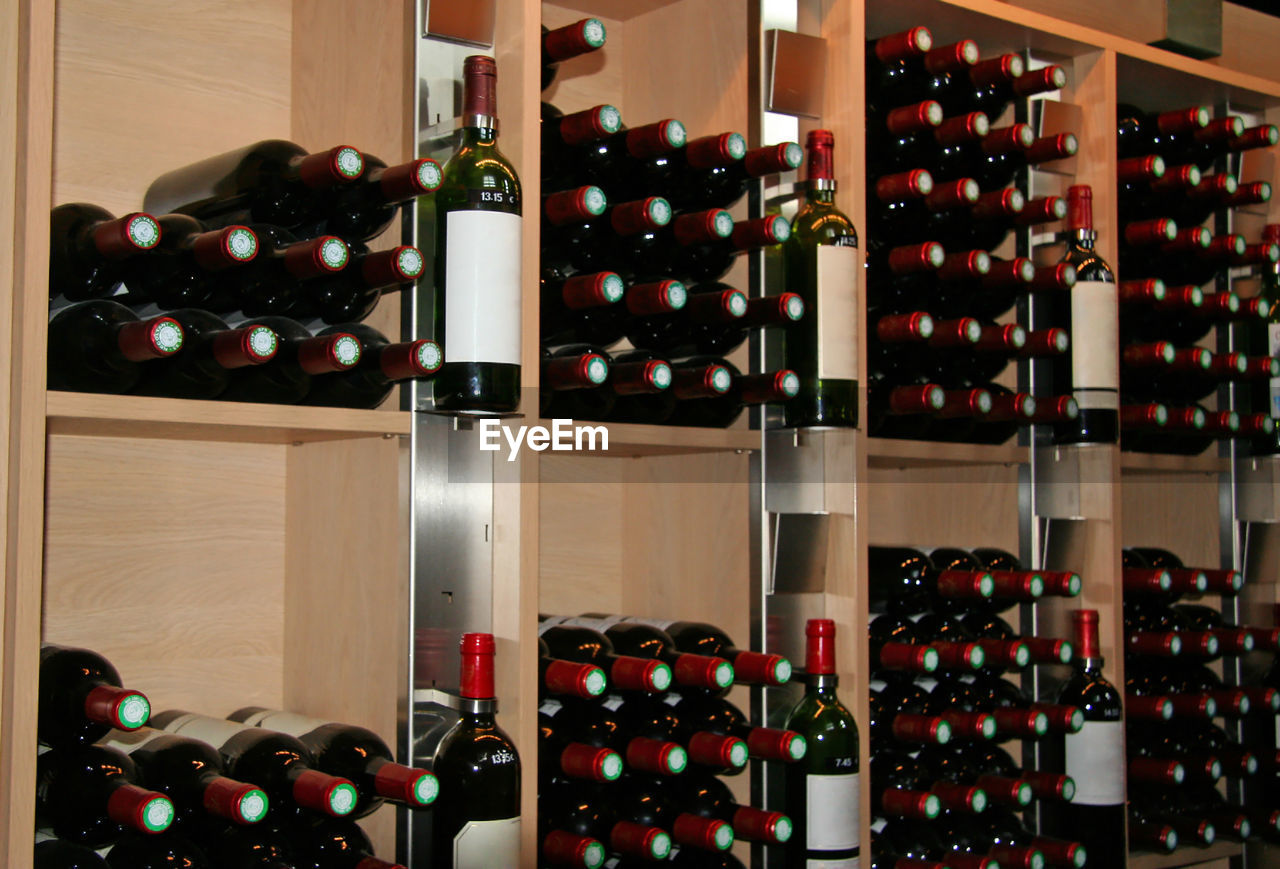 ROW OF WINE BOTTLES IN SHELF