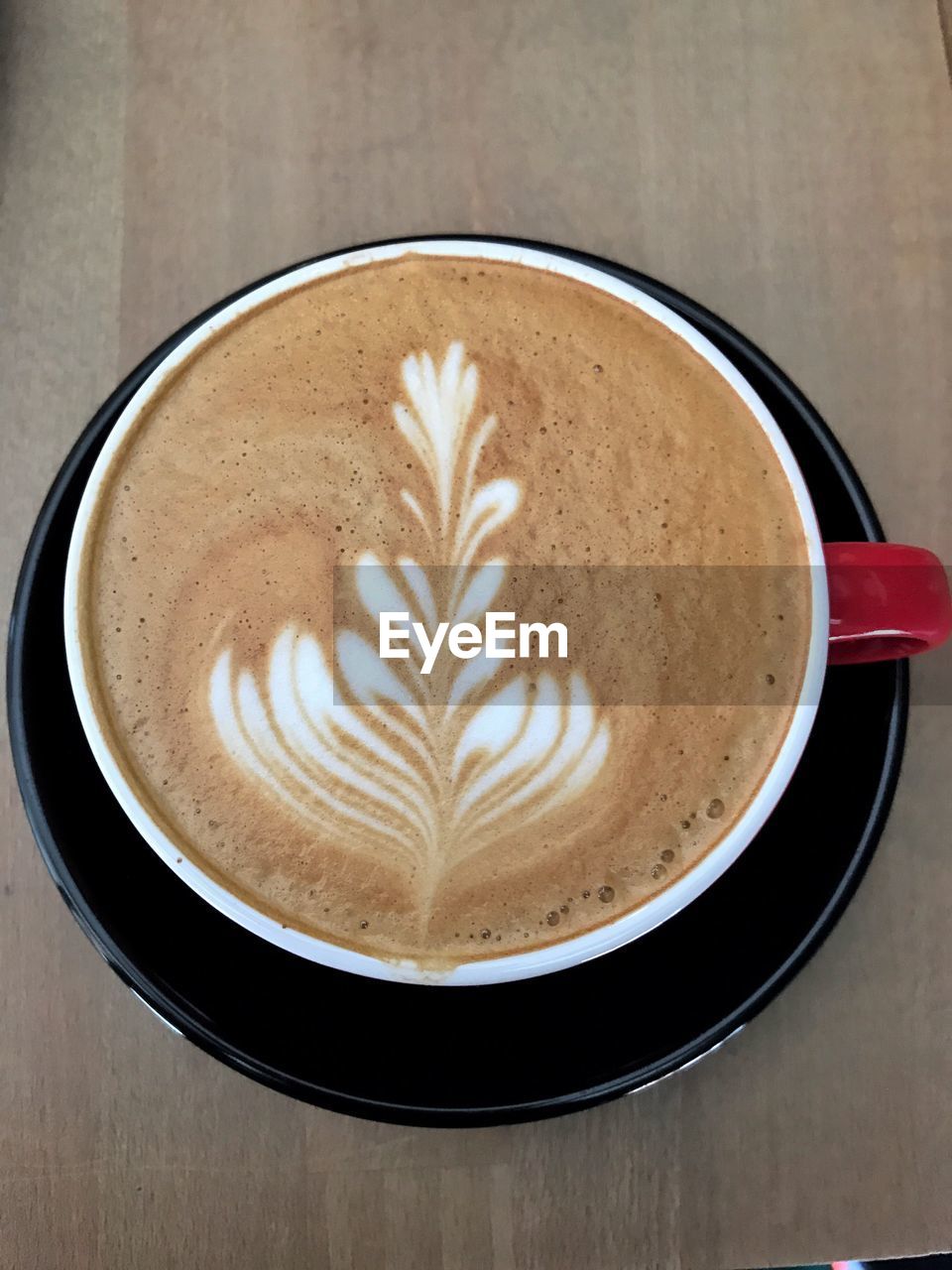 CLOSE-UP OF CAPPUCCINO ON TABLE