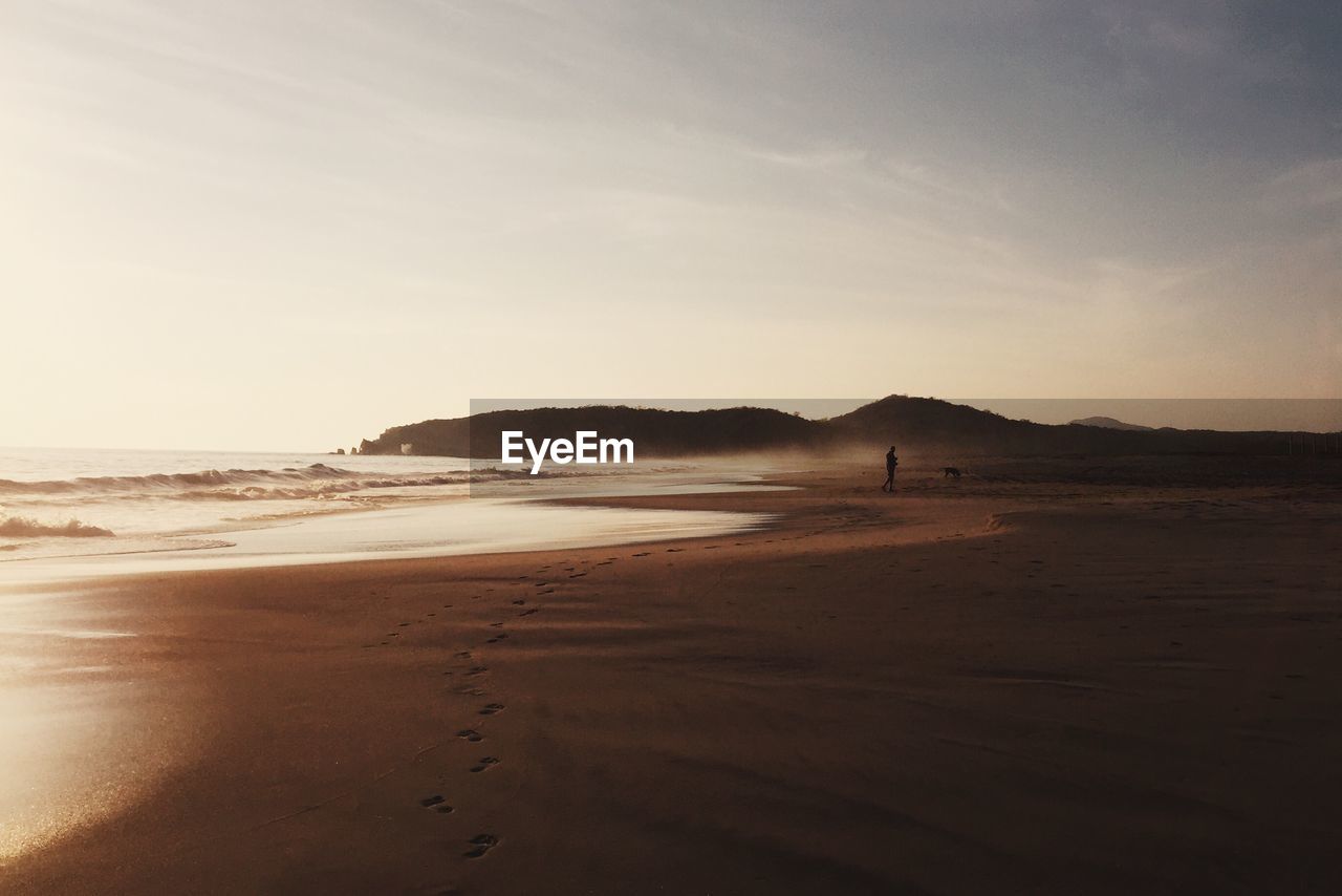 Scenic view of beach against sky during sunset