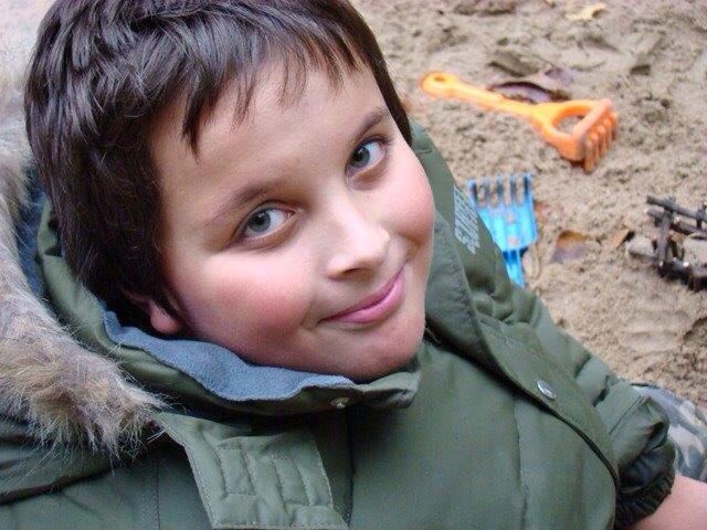 Portrait of boy with warm clothing on beach