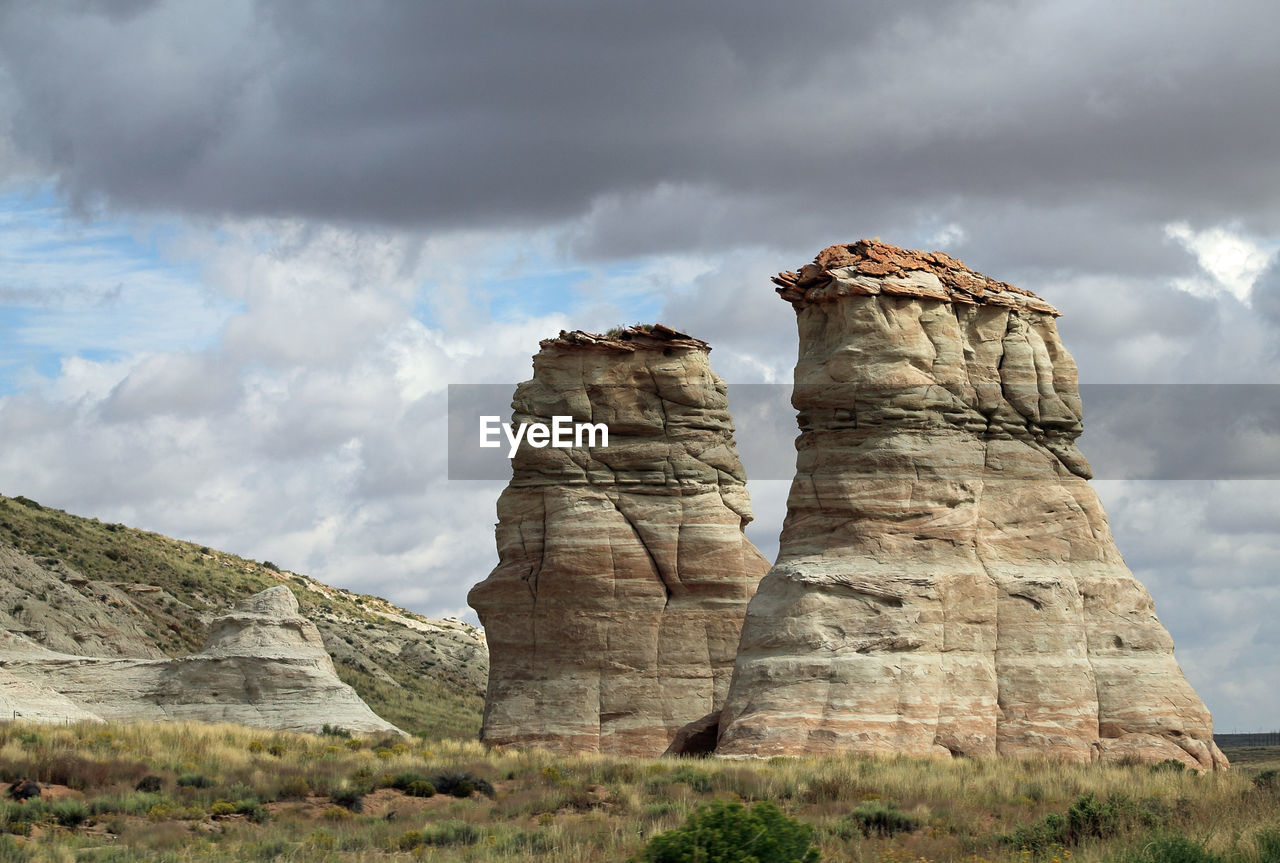 Scenic view of rock formations on landscape against sky