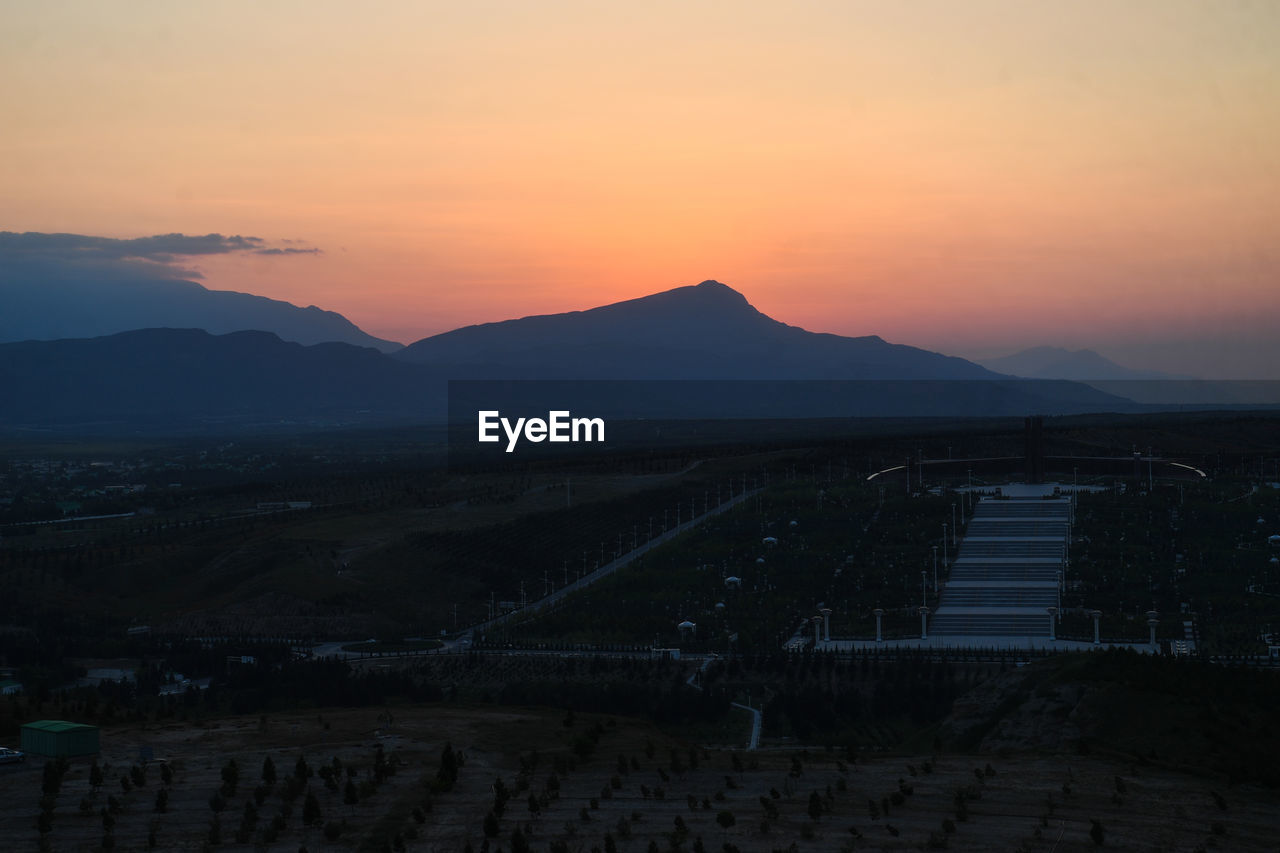 Scenic view of silhouette mountains against sky during sunset