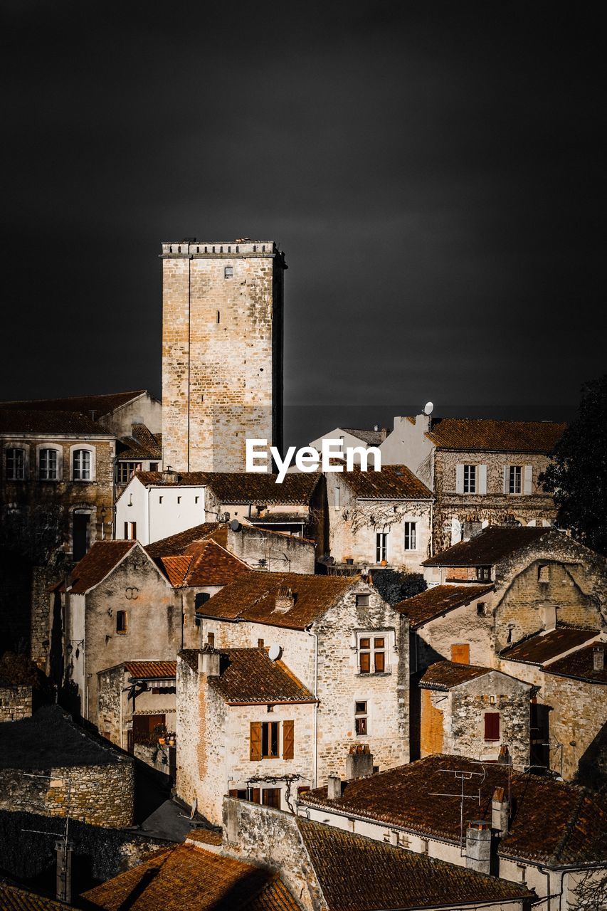 High angle view of old buildings in village against sky