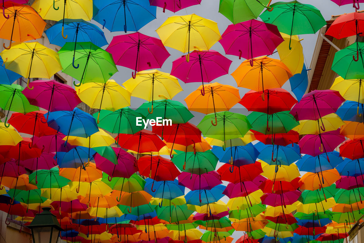 Collored umbrellas hanging on street to provide shadow from the hot sun