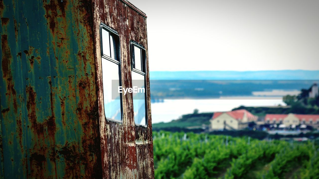 CLOSE-UP OF RUSTY WINDOW