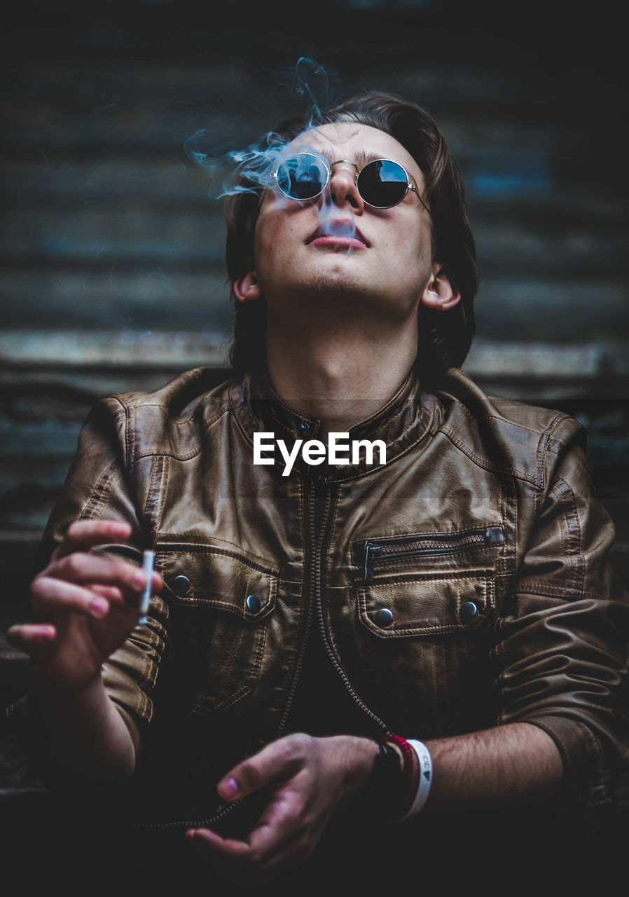 Man in sunglasses smoking cigarette