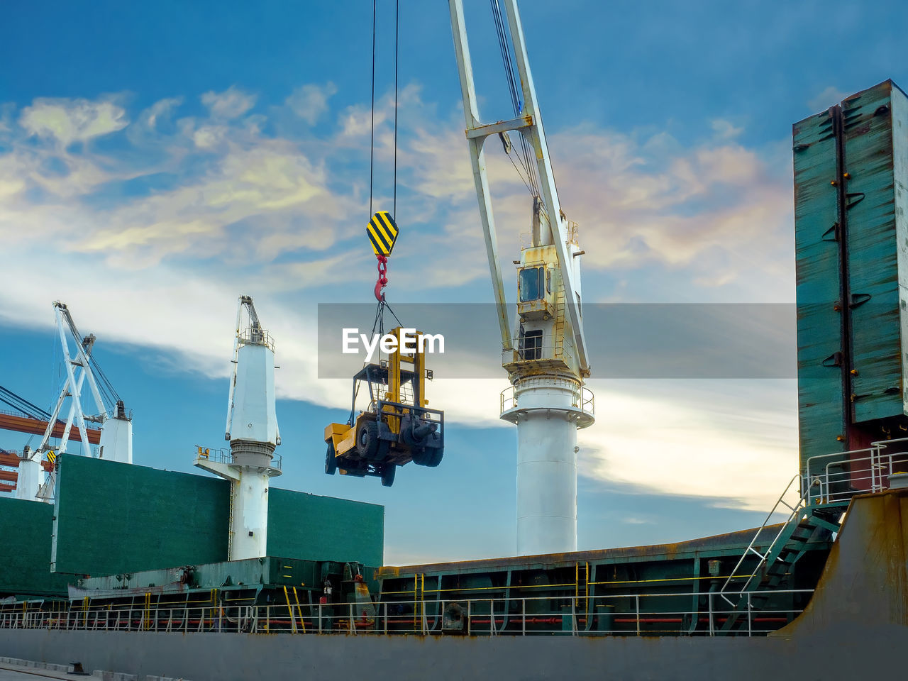 The vessel is loading equipment/forklift on board at industrial port of thailand