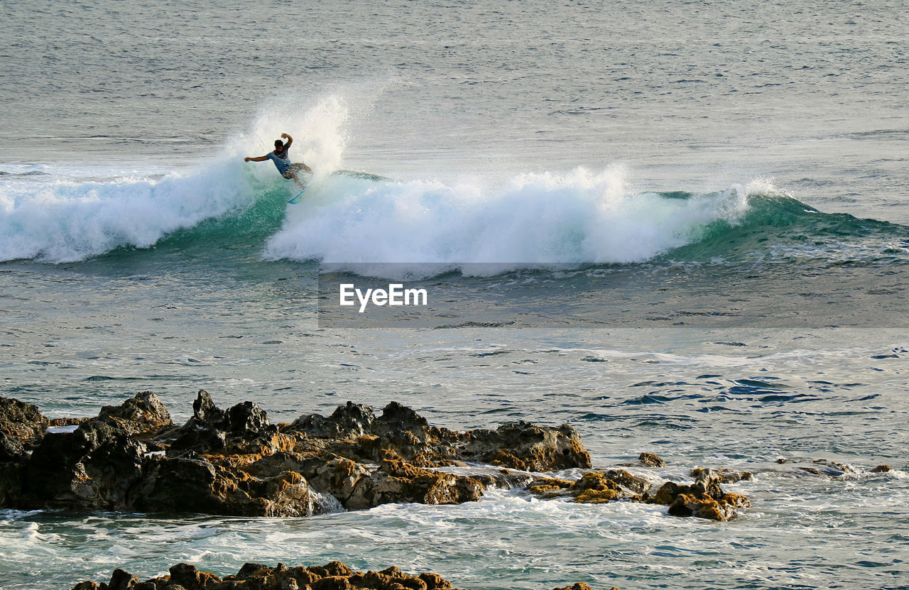 Full length of man surfing in sea