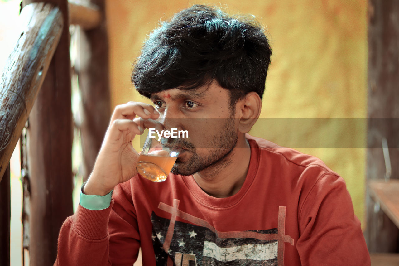 Man drinking tea while sitting outdoors