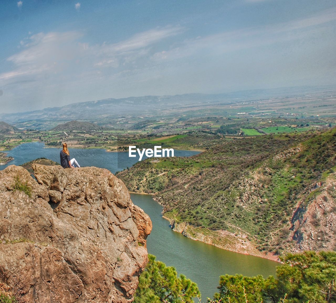 Woman looking at view of mountain against sky