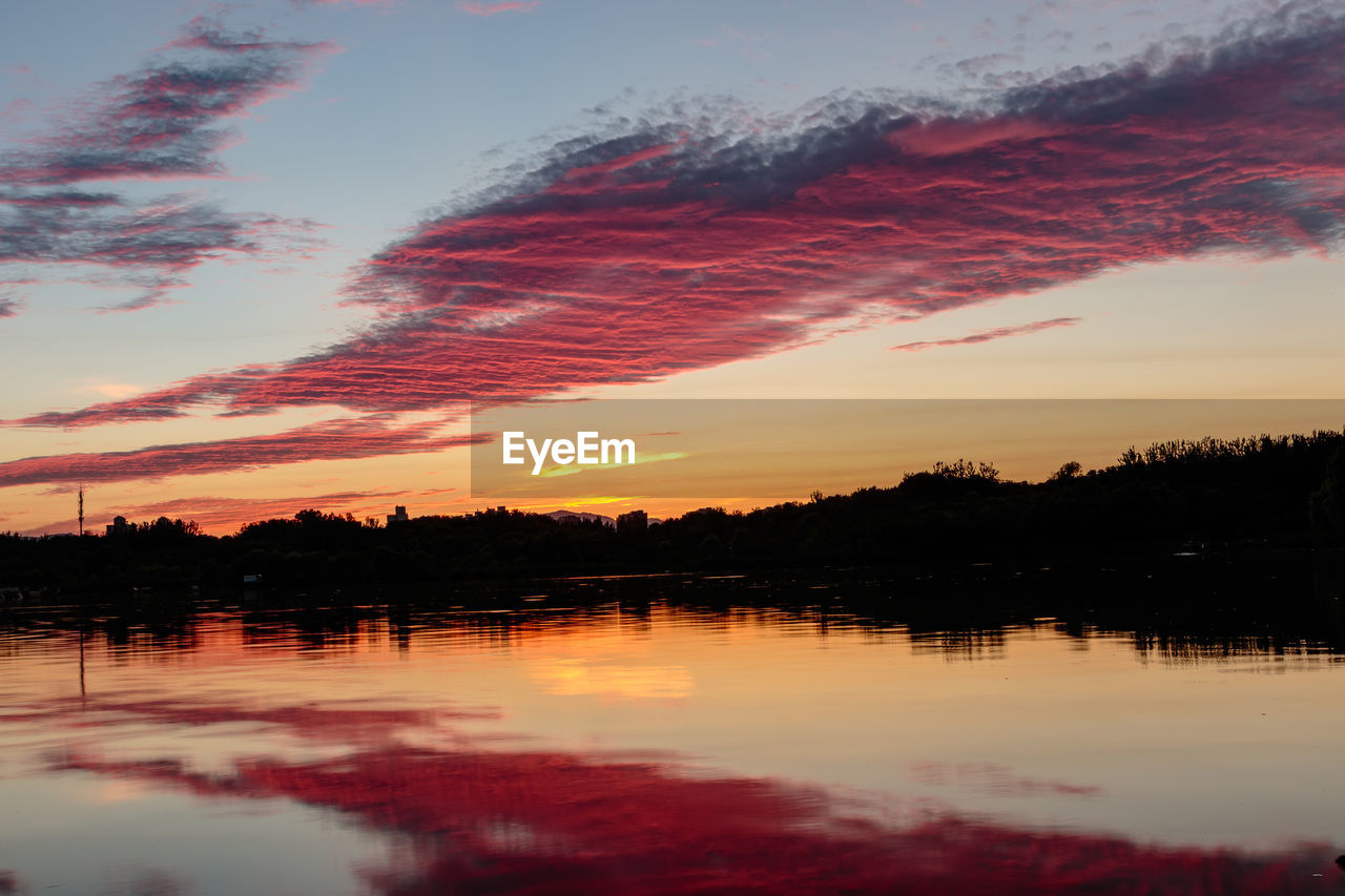 Scenic view of lake against sky during sunset