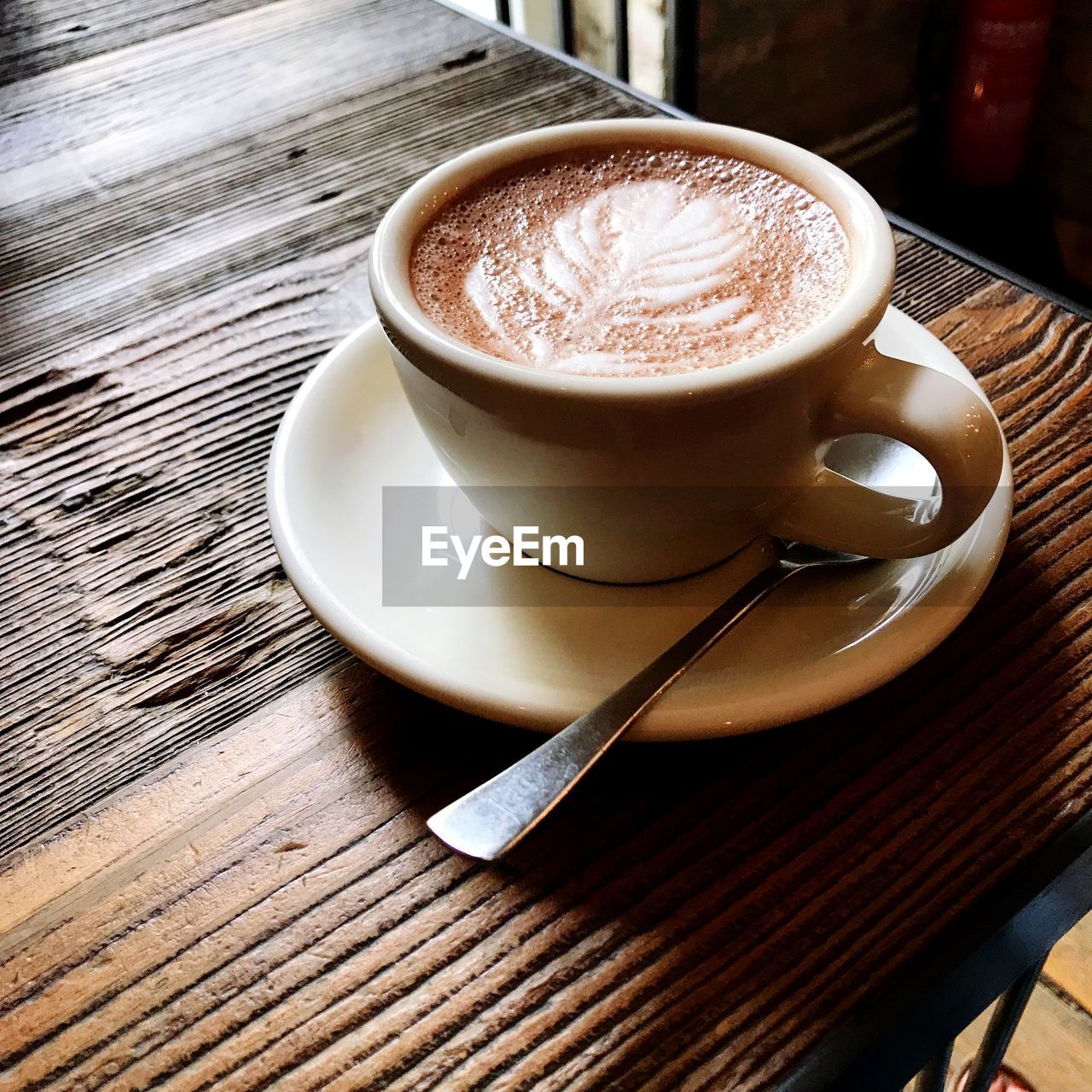 HIGH ANGLE VIEW OF COFFEE CUP WITH TEA ON TABLE