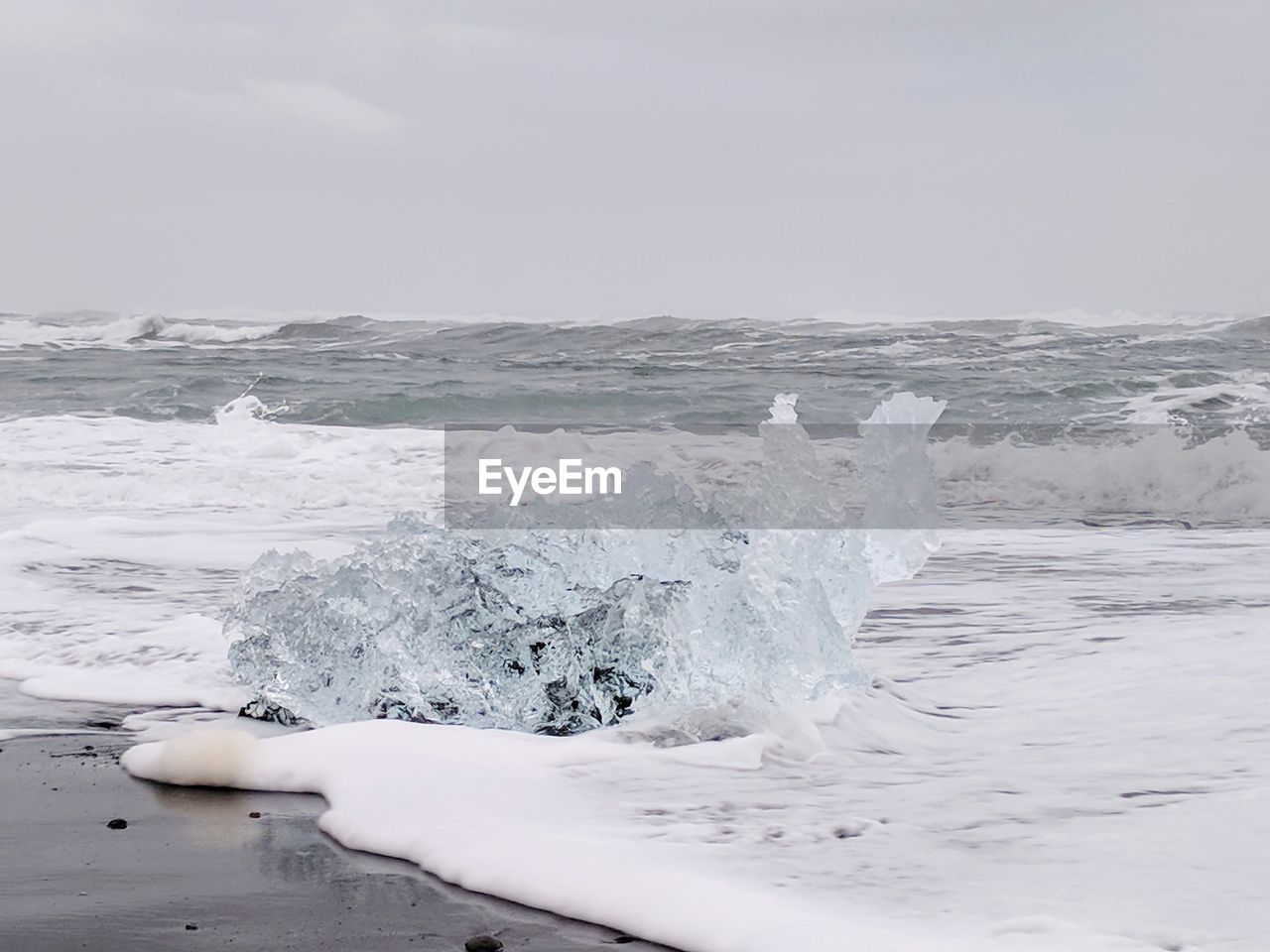 WAVES SPLASHING ON SHORE DURING WINTER