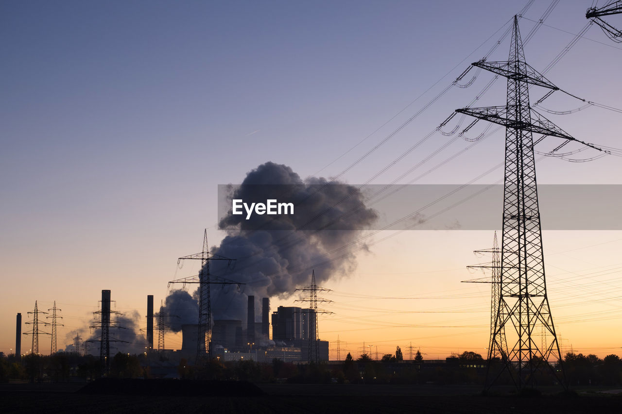 LOW ANGLE VIEW OF SMOKE STACKS AGAINST CLEAR SKY