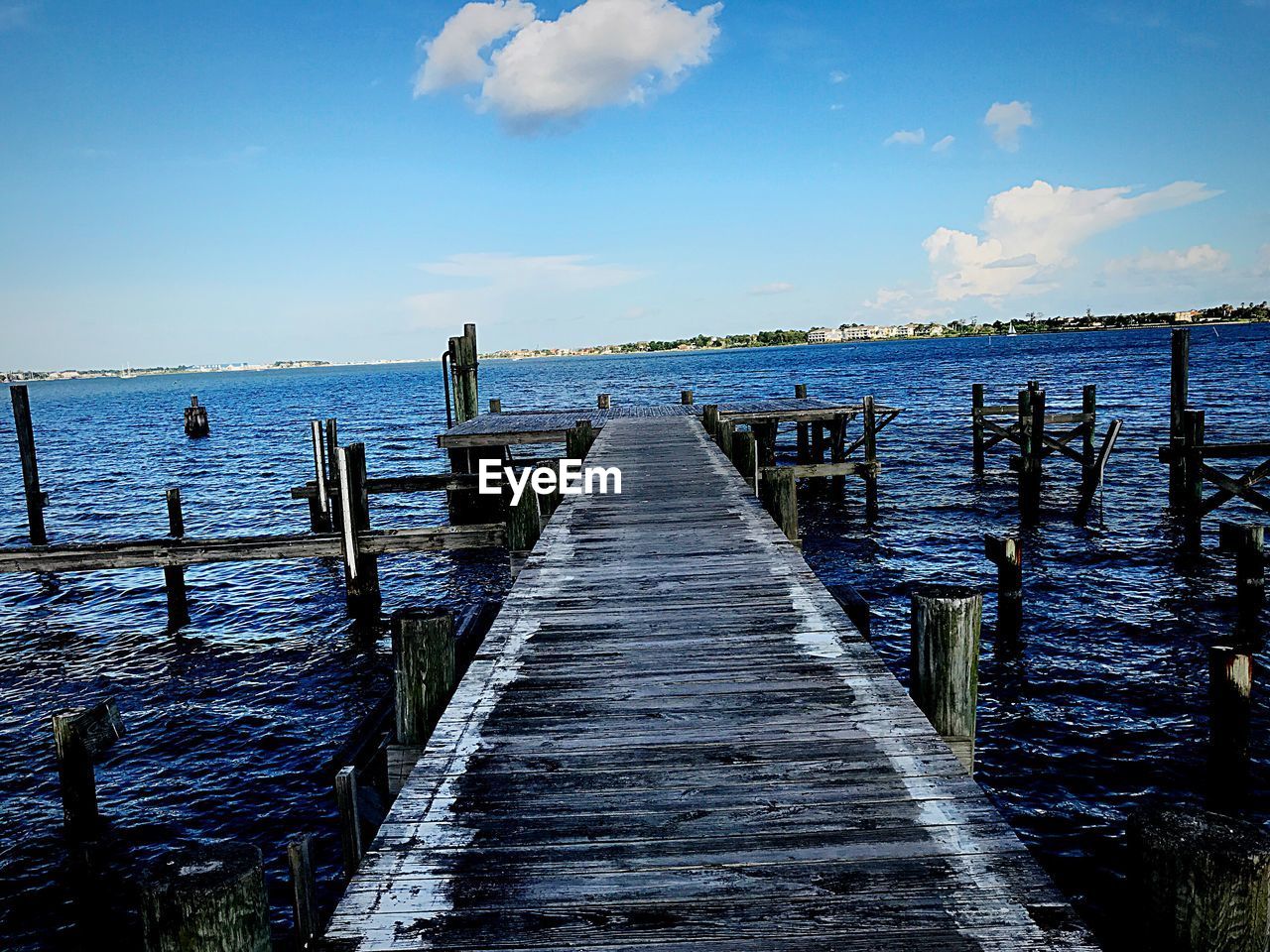 PIER AMIDST SEA AGAINST SKY