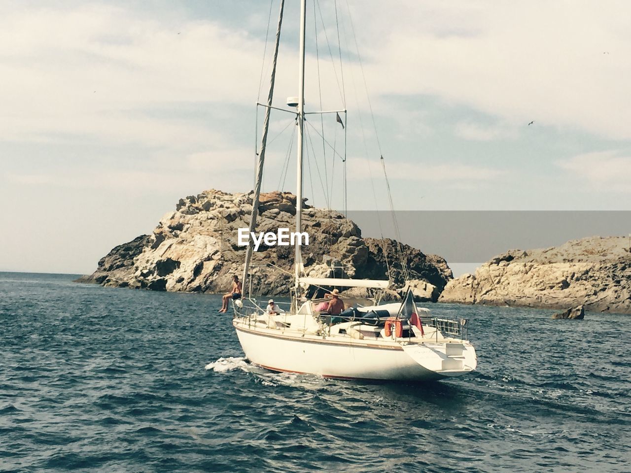 Boat sailing in sea against sky