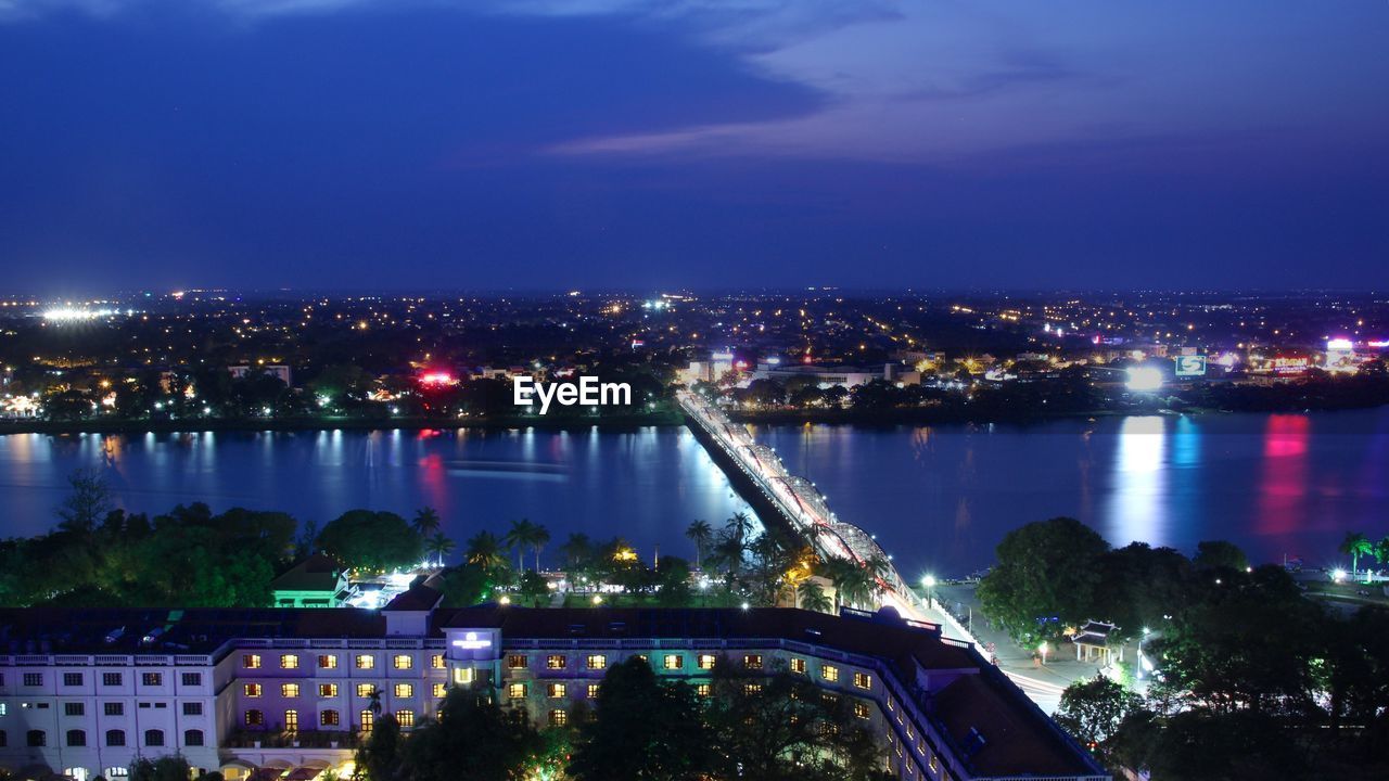 High angle view of city lit up at night