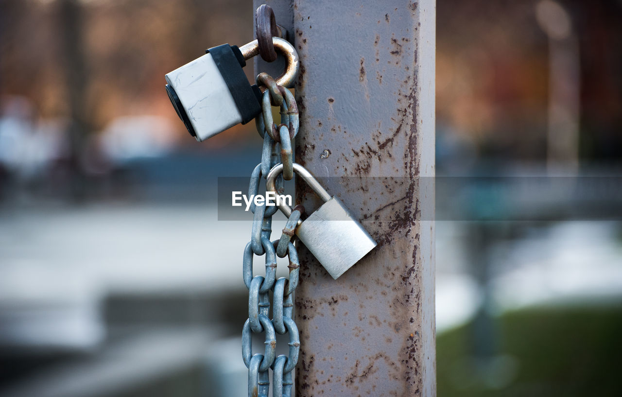 Close-up of padlocks on metal chain