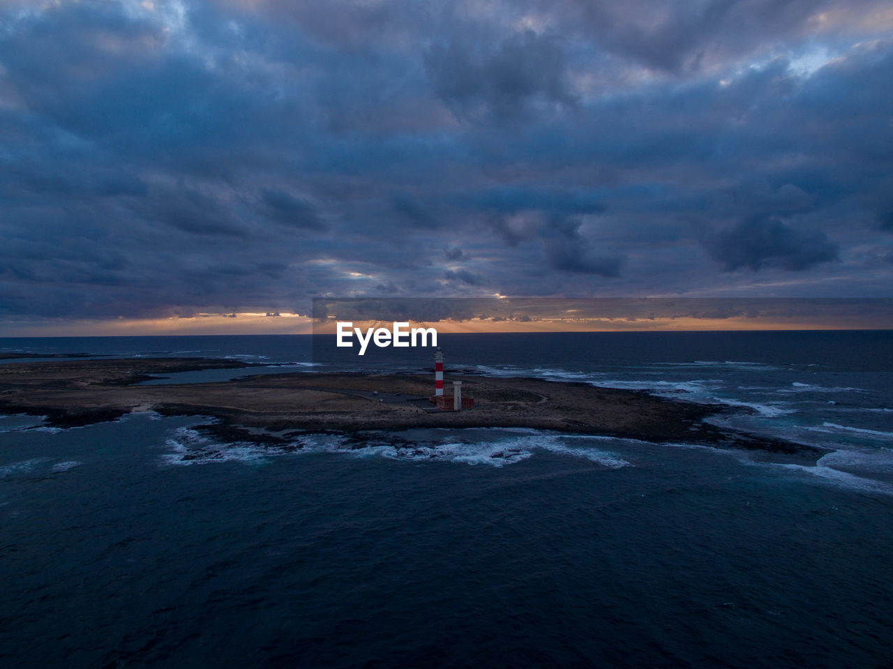 Scenic view of beach against sky during sunset