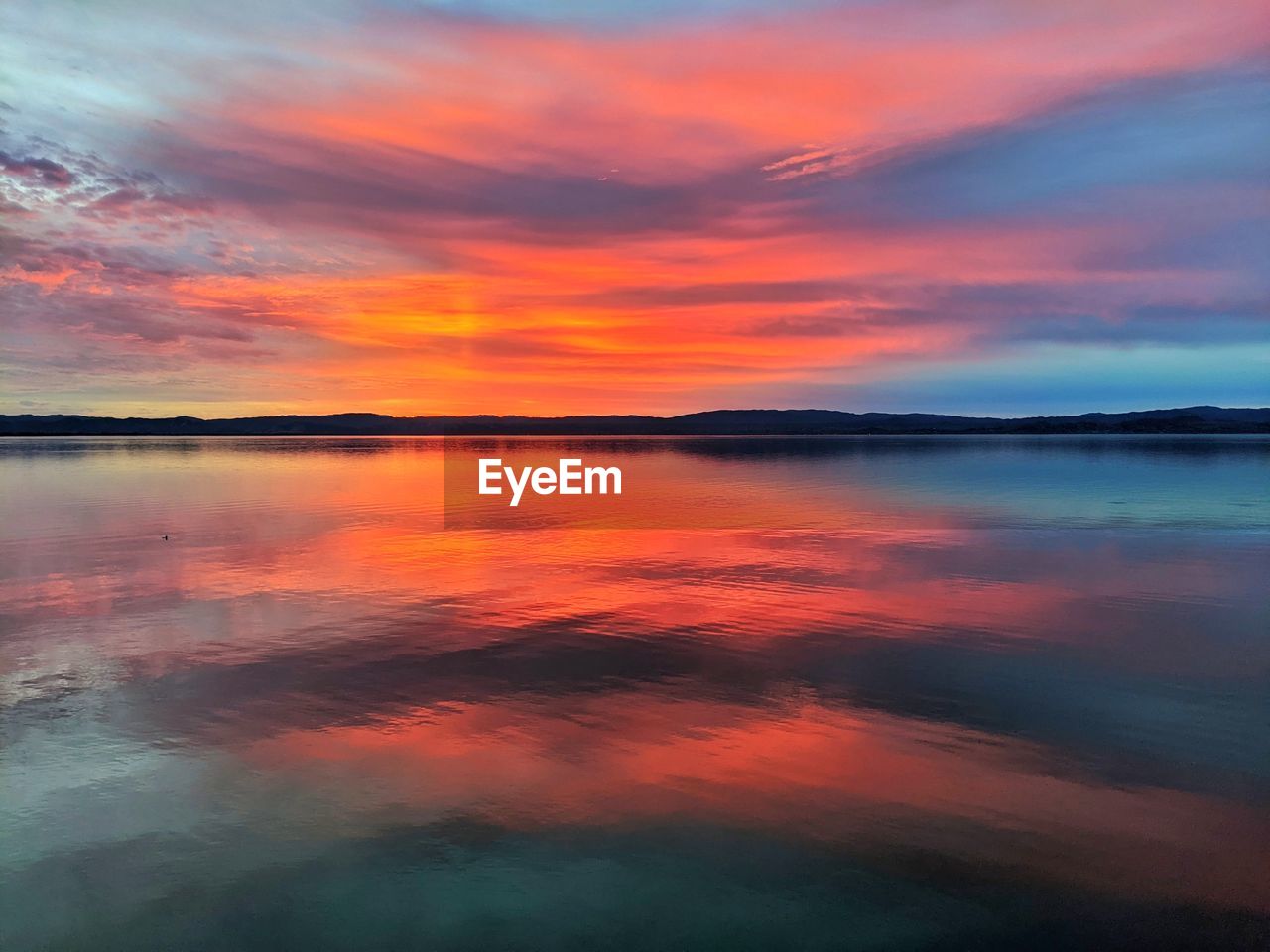 SCENIC VIEW OF LAKE AGAINST ROMANTIC SKY