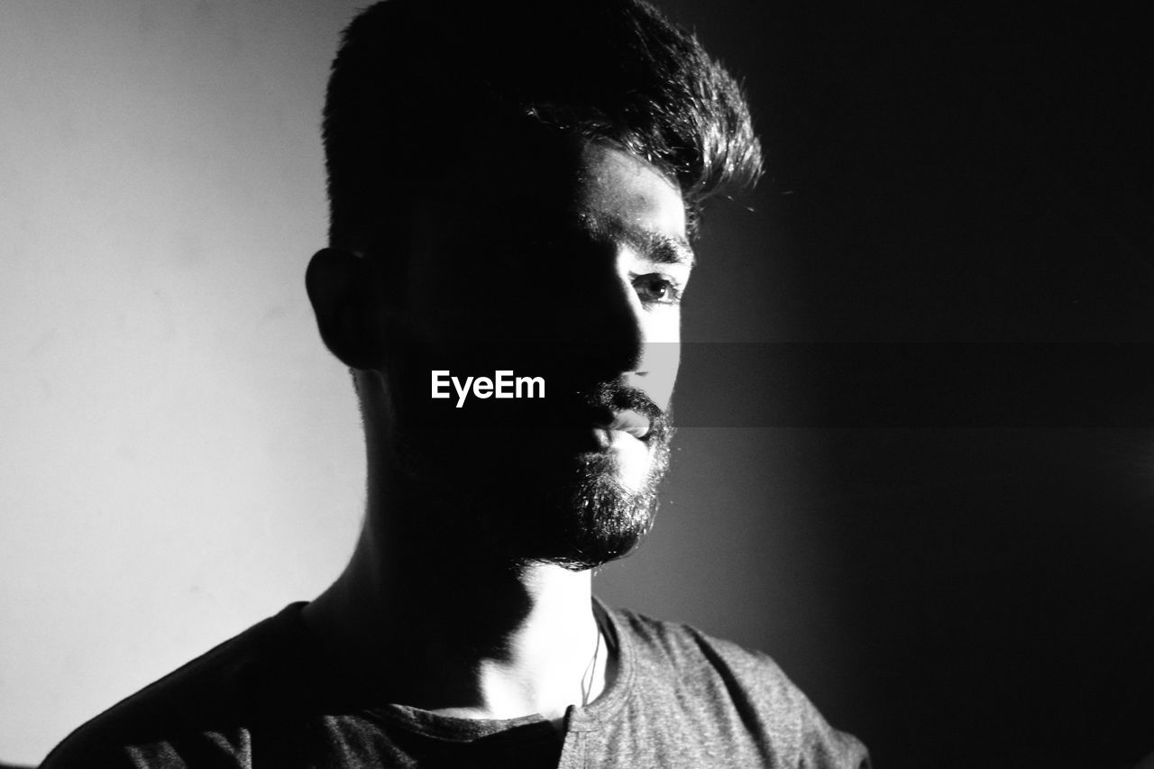 Close-up of thoughtful man in darkroom