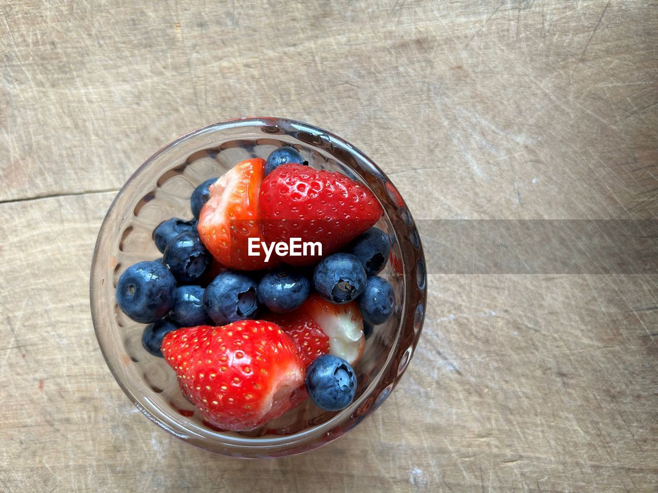 berry, healthy eating, food and drink, food, fruit, freshness, strawberry, wellbeing, plant, bowl, high angle view, blueberry, directly above, table, breakfast, produce, indoors, meal, wood, still life, no people, raspberry, red, dessert, berries, close-up, container