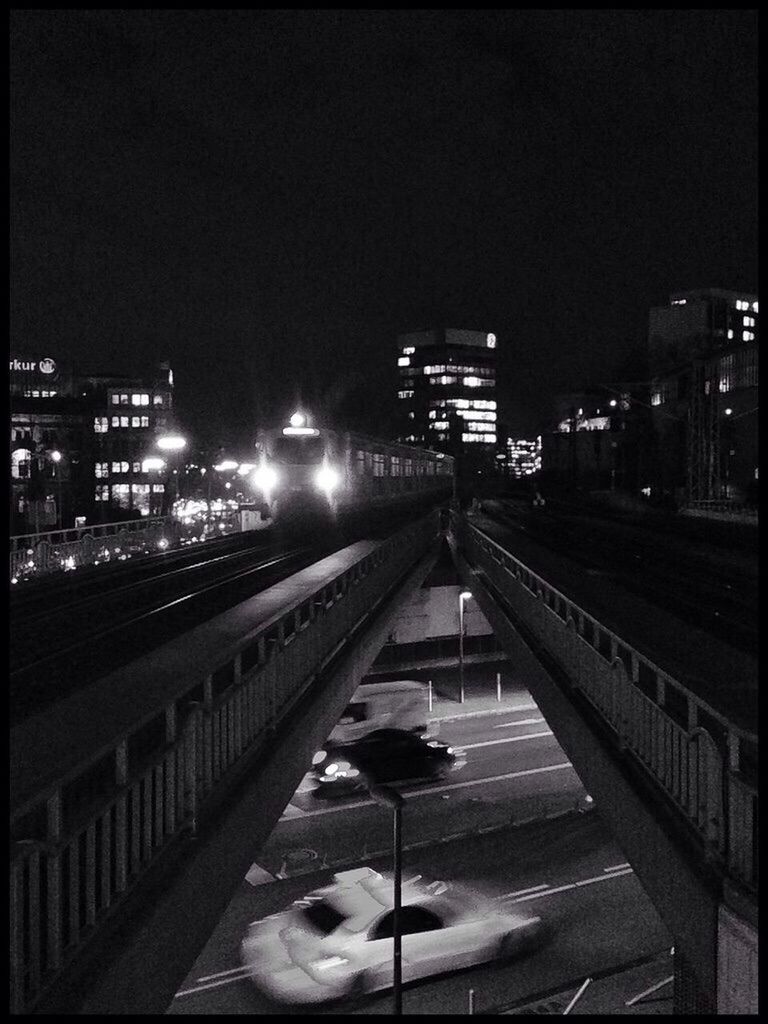 Train on railway bridge at night