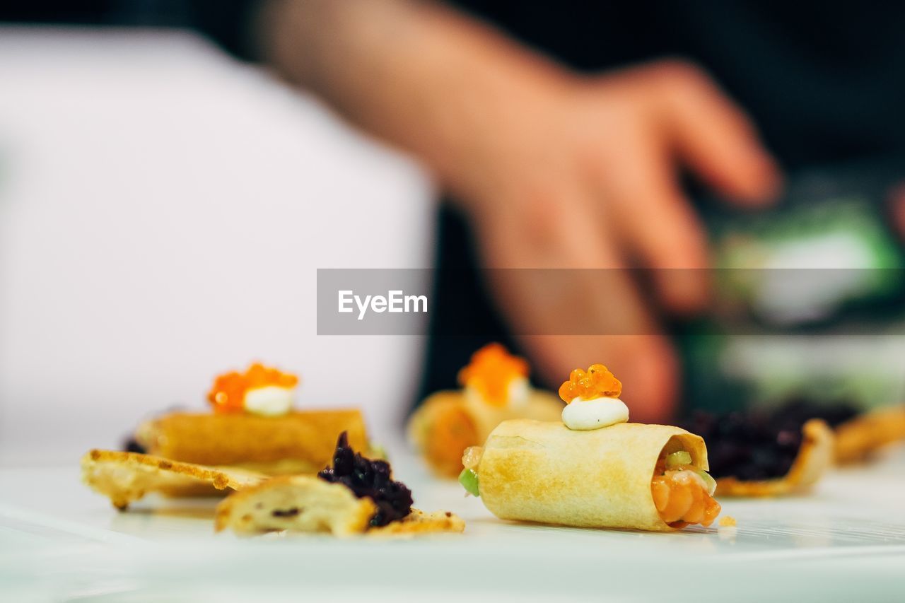 Close-up of appetizer served on table with man in background