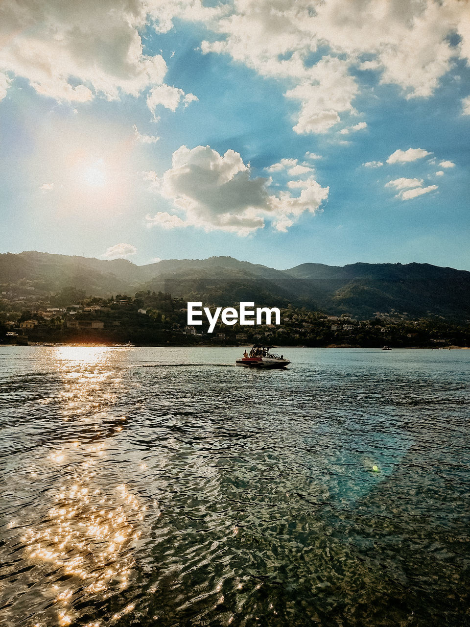 water, sky, reflection, sea, cloud, mountain, transportation, nautical vessel, nature, mode of transportation, scenics - nature, shore, morning, horizon, beauty in nature, body of water, sunlight, travel, dusk, mountain range, travel destinations, coast, tranquility, outdoors, ocean, land, no people, environment, day, tranquil scene, ship, beach, vehicle, landscape, holiday, bay, vacation, trip, wave