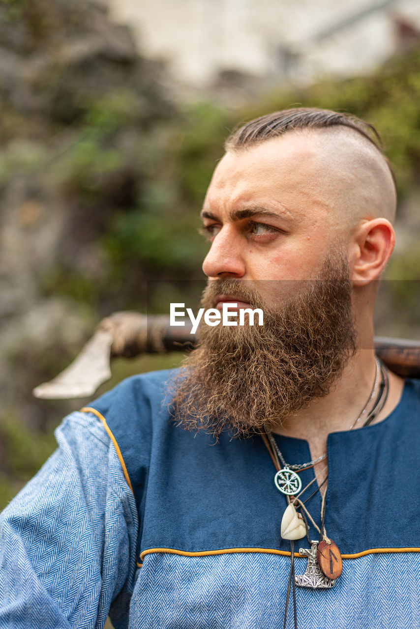 Close-up of man looking away outdoors