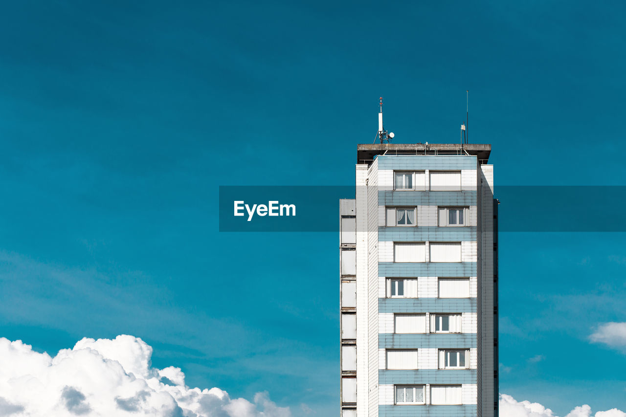 Low angle view of building against blue sky during sunny day