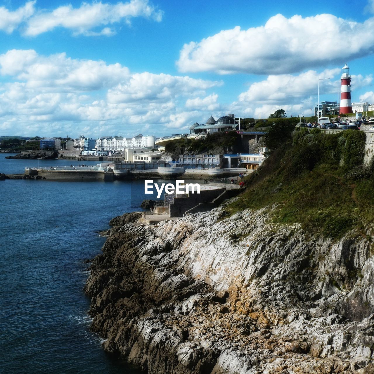 BUILDINGS BY SEA AGAINST SKY