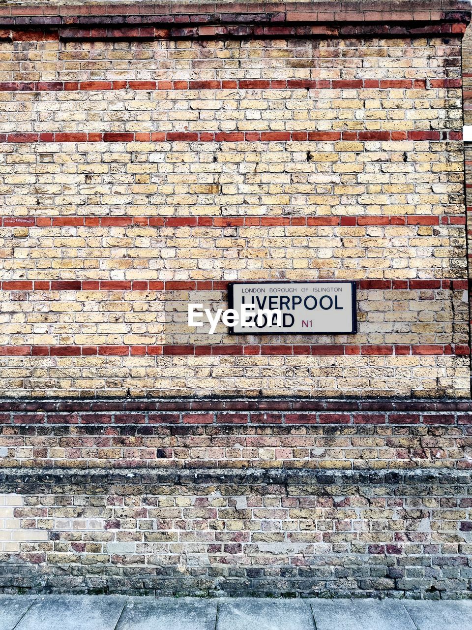 text, communication, western script, wood, wall, no people, architecture, brick, sign, built structure, day, wall - building feature, brick wall, building exterior, non-western script, script, weathered, outdoors, urban area, art, old, brickwork, information sign