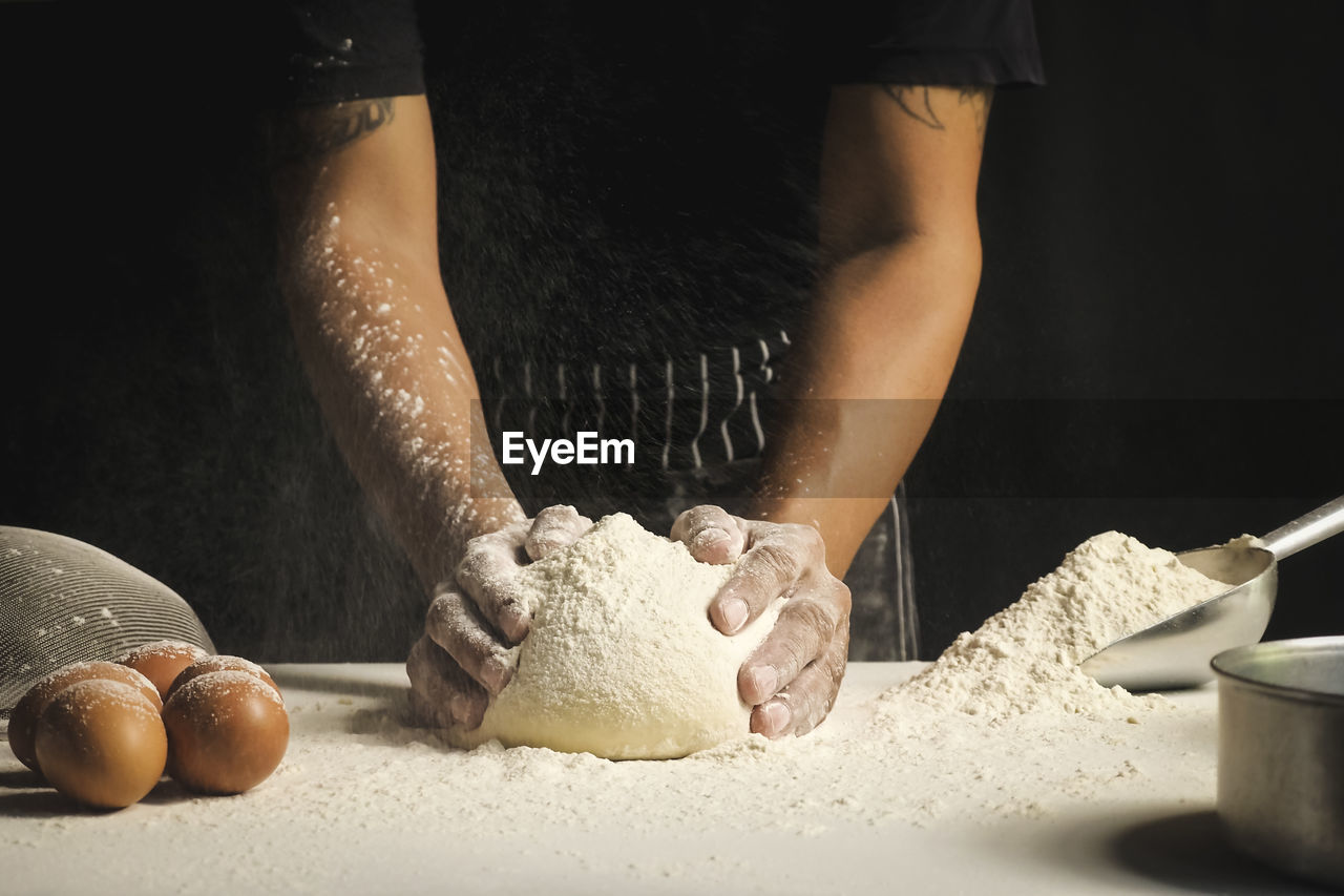 MIDSECTION OF MAN PREPARING FOOD