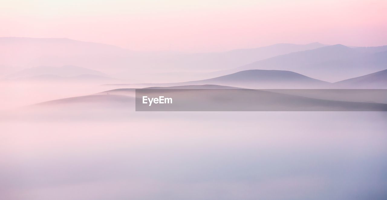 Scenic view of mountains against sky during sunset