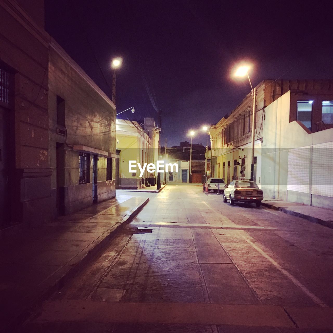 VIEW OF ILLUMINATED STREET LIGHTS AT NIGHT