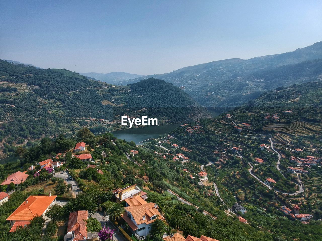 Aerial view of townscape and mountains against sky