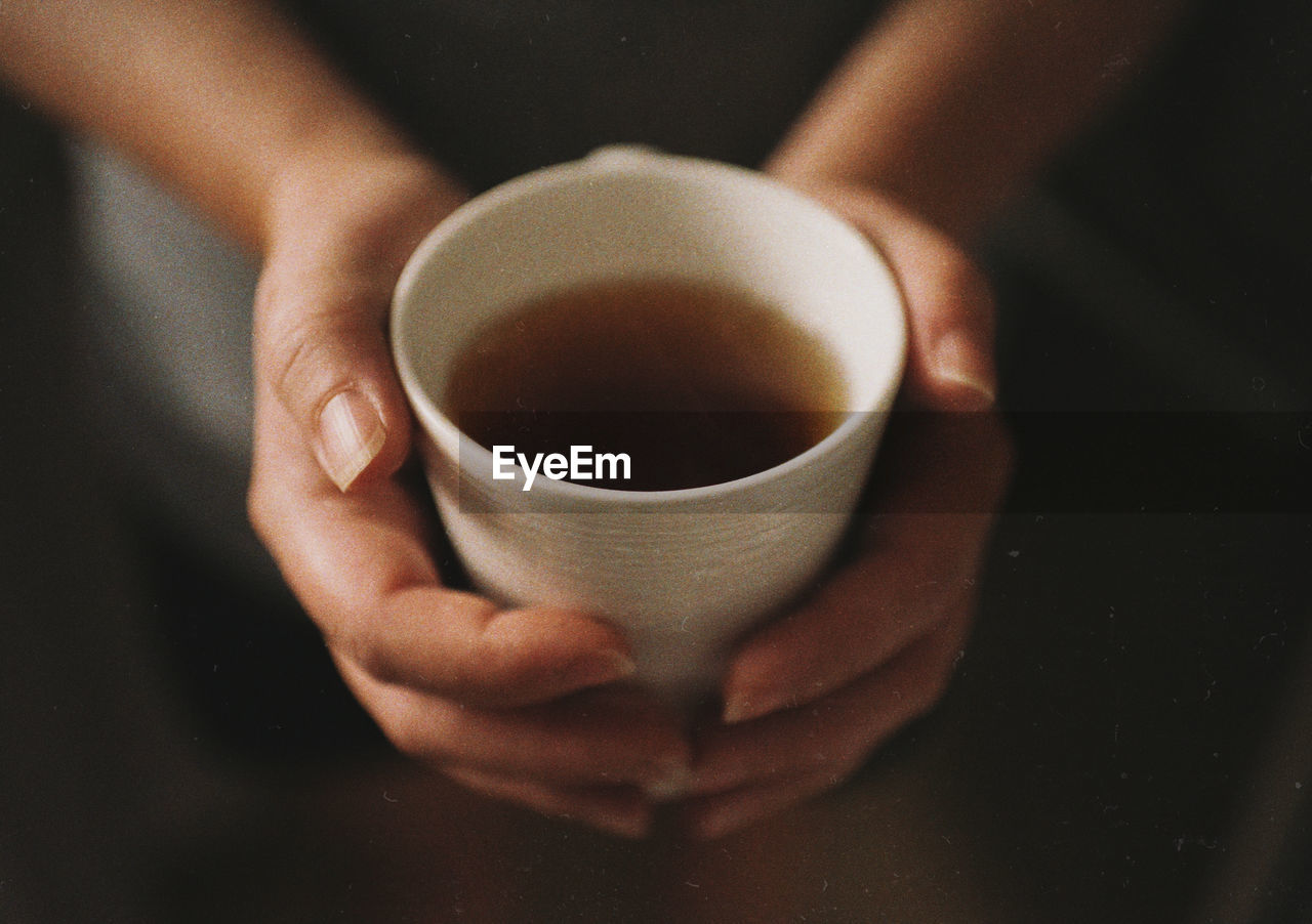 Young woman holding a cup of tea