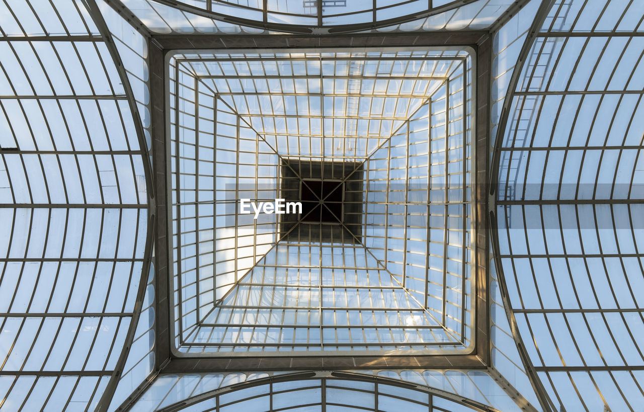 Low angle view of skylight in crystal palace of retiro park of madrid, spain.