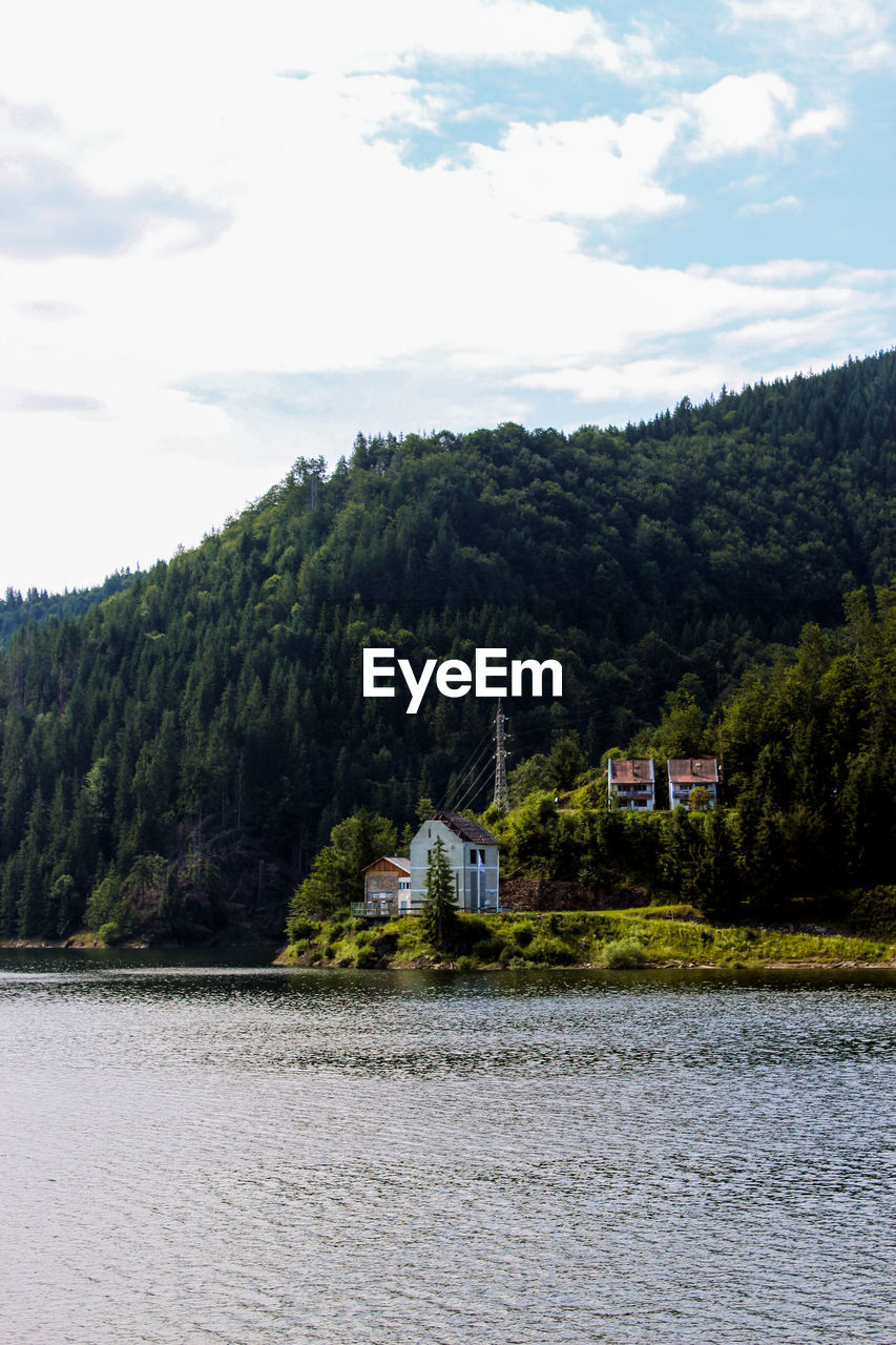 LAKE BY BUILDING AGAINST SKY